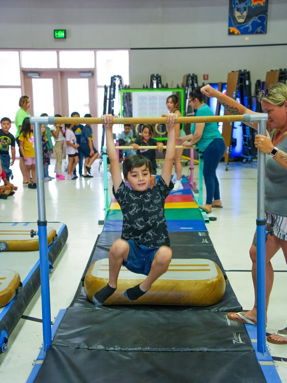 little boy on gym bar